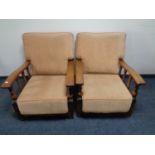 A pair of Edwardian oak adjustable armchairs