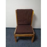 A mid century teak framed high backed chair with brown cushions