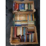 Three boxes of 20th century hardback and paperback books to include Penguin, Charles Dickens,