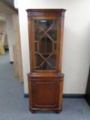 A corner display cabinet, fitted cupboard beneath.