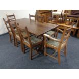 An oak refectory dining table and set of six ladder back chairs