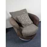 A swivel lounge armchair in a two tone brown fabric.