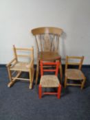 A pine kitchen chair together with two rush seated child's chairs and a further pine rush seated
