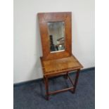 A walnut veneered occasional table and a wall mirror