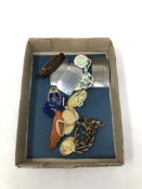 A box containing railway and horse racing memorabilia including badges, enamel fobs.