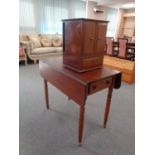 A 19th century mahogany drop leaf table together with a mahogany double door counter top cabinet