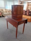 A 19th century mahogany drop leaf table together with a mahogany double door counter top cabinet