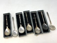 A collection of seven silver apostle spoons each showing a different saint (five boxed)