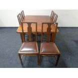 A nineteenth century mahogany wind out dining table together with a set of six later dining chairs