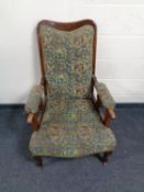 A late 19th century armchair upholstered in a tapestry fabric