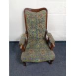 A late 19th century armchair upholstered in a tapestry fabric