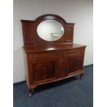 A mahogany bow fronted Queen Anne style mirror backed sideboard