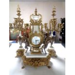 An impressive brass and white marble French three piece Imperial clock garniture