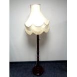 A stained beech standard lamp with shade