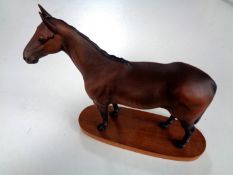 A Royal Doulton figure of a horse - Arkle Champion Steeplechaser on wooden plinth