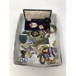 A box containing miscellaneous badges, commemorative medals, napkin rings etc.
