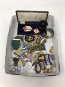 A box containing miscellaneous badges, commemorative medals, napkin rings etc.