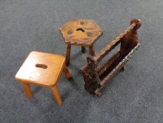 A rustic pine milking stool together with a rustic pine magazine rack and a further four legged