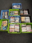 Nine plastic boxes containing a large quantity of assorted DVDs to include children's action movies