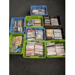 Nine plastic boxes containing a large quantity of assorted DVDs to include children's action movies