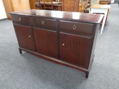 A Stag Minstrel triple door sideboard fitted three drawers