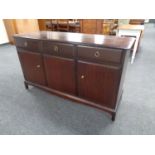 A Stag Minstrel triple door sideboard fitted three drawers