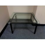 A contemporary glass topped coffee table.