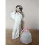 A Lladro figure of a cherub and a Lladro 1987 Christmas bell