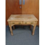 An antique pine side table fitted two drawers