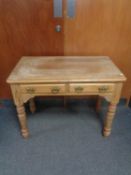 An antique pine side table fitted two drawers