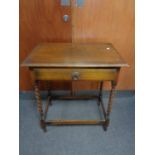 An Edwardian oak barley twist occasional table fitted a drawer