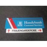 A German metal enamelled sign Frauengarderobe (Women's Wardrobe) and a perspex Co-operative Bank