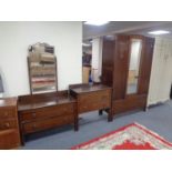 A three piece 1930s oak bedroom suite comprising of mirror door wardrobe,