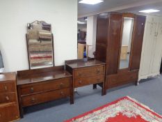A three piece 1930s oak bedroom suite comprising of mirror door wardrobe,