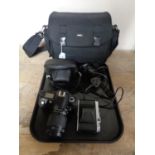 A camera bag of Pentax K1000 camera with 50 mm lens, Nikon D70 digital camera with lens,