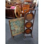 A three tier folding oak cake stand together with a folding tapestry fire screen table