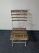 A folding wooden metal slatted chair