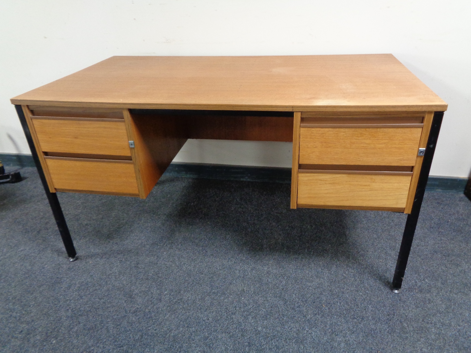 A 20th century teak twin pedestal desk on metal legs