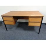 A 20th century teak twin pedestal desk on metal legs