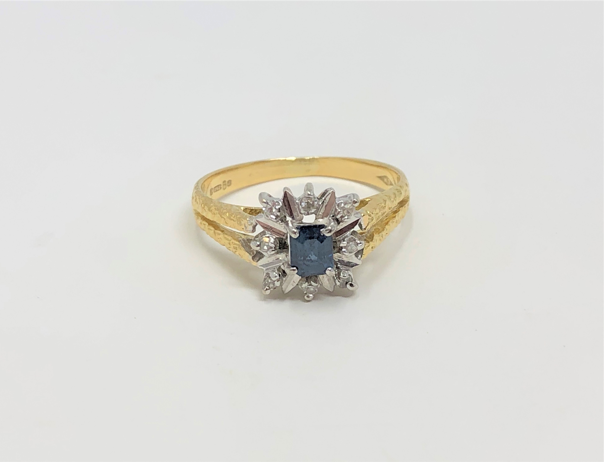 An 18ct gold sapphire and diamond cluster ring, size M CONDITION REPORT: 3.