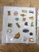 A quantity of continental enamelled pin badges on card