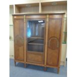 A continental inlaid oak triple door cabinet with brass mounts.