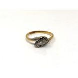 An 18ct gold and platinum three stone diamond crossover ring,