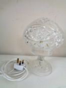 A cut glass table lamp with shade