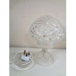 A cut glass table lamp with shade