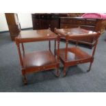 A pair of Regency style two tier occasional tables on castors