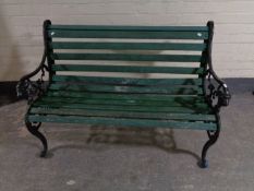 A cast iron wooden slatted garden bench