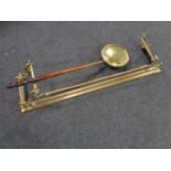 A brass Art Nouveau fire curb together with a brass wooden handled bed warming pan.