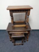 An Edwardian joined oak stool and a nest of three similar oak tables