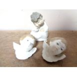 A Lladro figure of a cherub and two Lladro cherub masks CONDITION REPORT: One mask